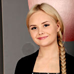 Second pic of Isabella Star strips on the red couch baring her delectable pussy. naked