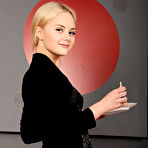 Third pic of Isabella Star strips on the red couch baring her delectable pussy. naked