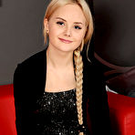 Fourth pic of Isabella Star strips on the red couch baring her delectable pussy. naked