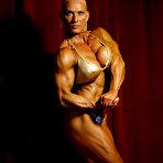 First pic of Big titted muscle woman Nicole Ball takes off her bikini to pose naked in the semi-dark