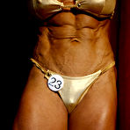 Fourth pic of Big titted muscle woman Nicole Ball takes off her bikini to pose naked in the semi-dark