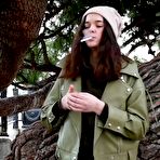 Fourth pic of Russian Smokers | Young brunette is taking an unhurried stroll with allwhite 120mm cigarette