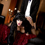 Third pic of Elvira-like brunette gets fucked by a big-dicked dude from behind - IamXXX.com