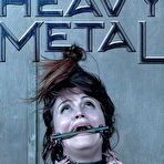 First pic of SexPreviews - Raquel Roper with purple top and high heels is bound in heavy metal for toying orgasms