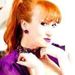 First pic of Red XXX toying on the bed in her purple gown and stockings