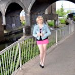 Third pic of Mature blonde with long legs wearing a short pink mini skirt flashes her bald pussy in public places &ndash; Bare Milfs