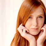 Fourth pic of Linda Sweet sits naked on the floor and massages her pussy and makes it wet