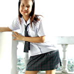 First pic of Asian student shows the pink of her teen pussy on a bed in socks