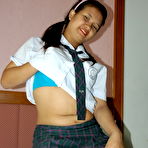 Second pic of Asian student shows the pink of her teen pussy on a bed in socks