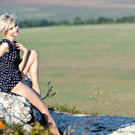 First pic of Blonde teen Azshara removes a polka dot dress to pose nude on high ground