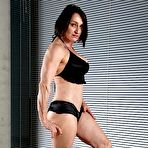 First pic of Female bodybuilder flexes after getting naked on a mat in black socks