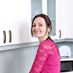 First pic of Slender brunette housewife Mariona strips to spread hairy pussy in the kitchen