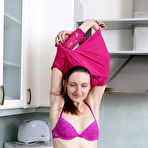 Third pic of Slender brunette housewife Mariona strips to spread hairy pussy in the kitchen