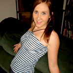 First pic of Young redhead gets naked on a sofa while wearing running shoes