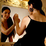 Second pic of Young brunette Electra Noir removes a little black dress to model in the nude