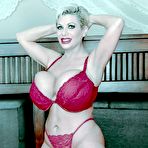 First pic of Mature lady with short hair Claudia Marie uncups huge tits before masturbating