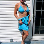 Second pic of Mature blonde Ruth frees her tits and ass from a bikini in sunglasses