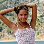 First pic of Solo girl Mango A modeling naked on rocky beach after disrobing
