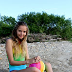Second pic of Sweet brunette filly Mango A reveals her shaved pussy at the beach