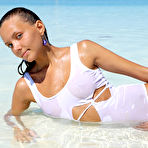 Third pic of Long legged bikni clad Mango A strips at the beach to show wet pussy