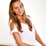 First pic of Blonde teen Mango A gets totally naked on satin cushions in a confident manner