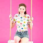 First pic of Young looking girl Tina strips totally naked on a swing in solo action