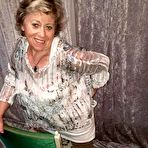 Second pic of Big titted oma Caro pulls down her underwear to show her big ass in nylons