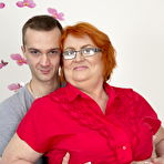 Fourth pic of Redheaded BBW and her boy toy start to undress as they engage in foreplay