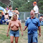 Second pic of Caucasian strippers put on an outdoor show at a clothing optional club