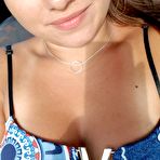 Third pic of Young looking Latina girl Olivia hides her huge tits while taking selfies