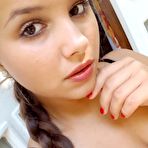 Fourth pic of Young looking Latina girl Olivia hides her huge tits while taking selfies