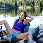 Third pic of Young girl Andi Land unveils her small tits and pussy while on a boat