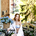 First pic of Redheaded teen Atika cups her full breasts while baring her skinny body