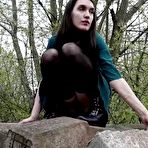 Second pic of Brunette girl Lara pees on concrete blocks while walking railway tracks
