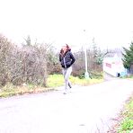 First pic of Redheaded girl pulls down her pants to take a piss in front of steel gates