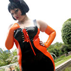 First pic of Brunette chick models latex clothing and over the knee boots near some water
