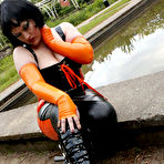 Second pic of Brunette chick models latex clothing and over the knee boots near some water