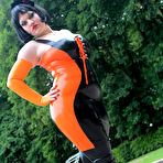 Fourth pic of Brunette chick models latex clothing and over the knee boots near some water