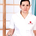 First pic of Brunette nurse Sharlyn spreads her hairy twat in white nylons and garters