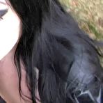 Fourth pic of Dark-haired goth Lady Angelina shows her big tits while giving an outdoor BJ