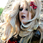 Third pic of Blonde female models non nude outside Castle ruins in latex clothing and boots