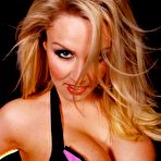 Fourth pic of Blonde MILF Dannii Harwood models a sexy PVC latex maid outfit in nylon hose