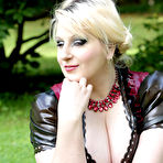 First pic of Overweight blonde Darkwing Zero models on a lawn in a rubber dress