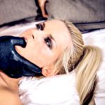 Fourth pic of Young blonde in latex leggings takes it hard from a man wearing latex gloves