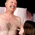 Fourth pic of Brunette woman tops a submissive old man while wearing red stockings