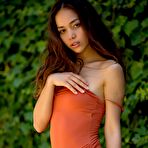 First pic of Petite brunette Kit Rysha frees her tiny tits from a swimsuit on a rocky shelf