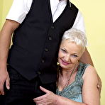 Second pic of Short haired cougar has her large boobs licked by her young lover boy