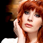 First pic of Beautiful redhead is restrained with ropes before being poked by dildo sticks