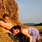 Second pic of Horny young couple has sex on a mound of loose straw in a field