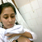 Second pic of Sexy Indian chick uncups saggy tits while getting naked during self shots